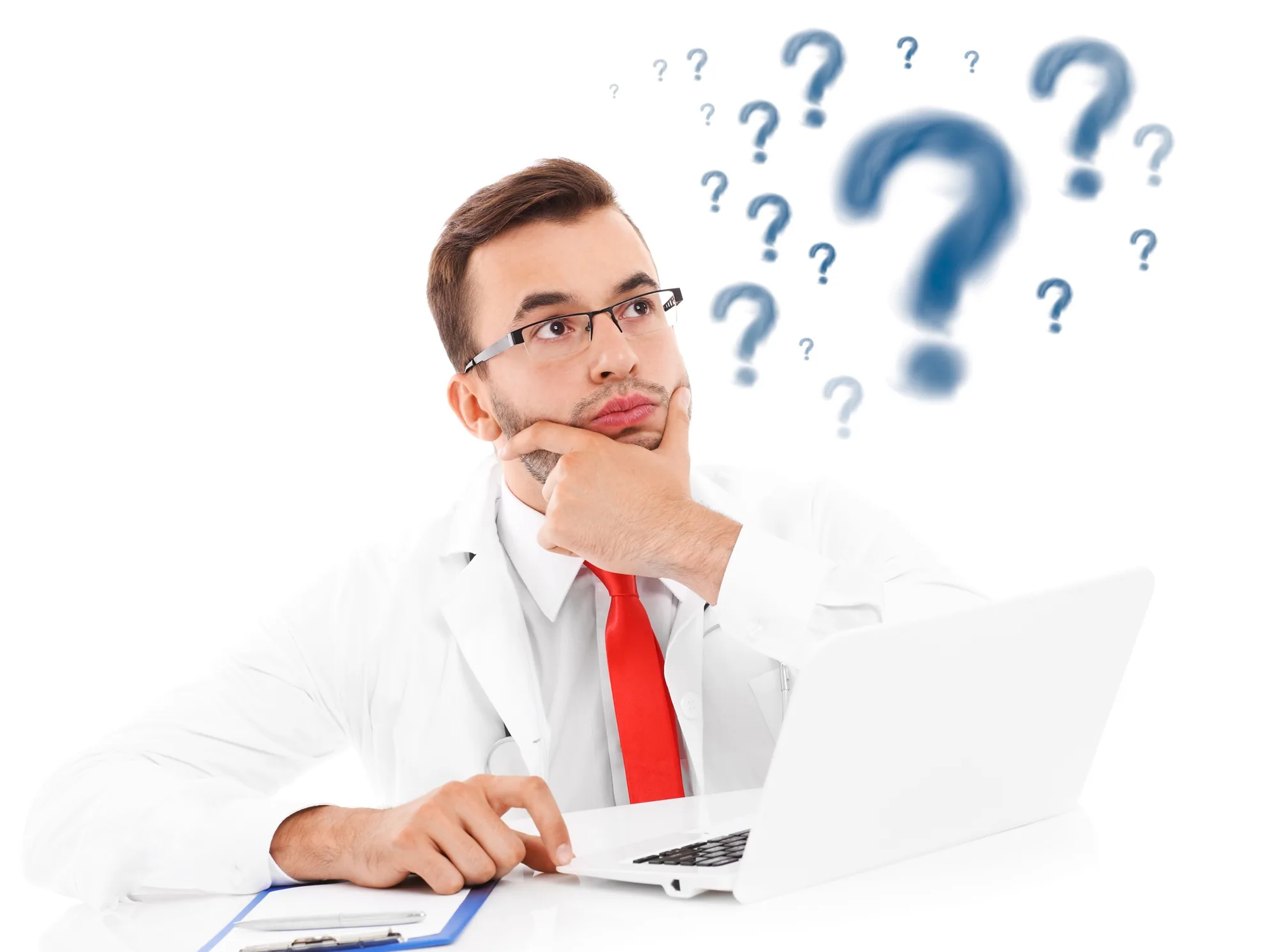 Male doctor in a white coat looking thoughtful while sitting at a laptop with question marks